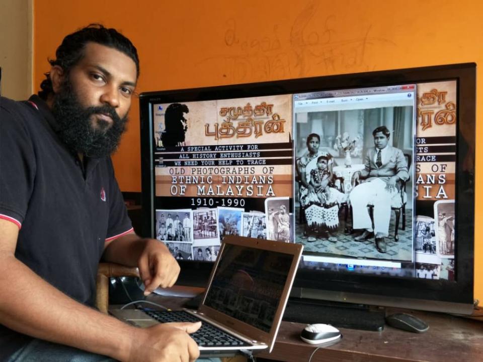 Film director JK Wicky posing with backdrop of an old picture of a family in 1938 and his poster for the initiative. — Picture courtesy of JK Wicky