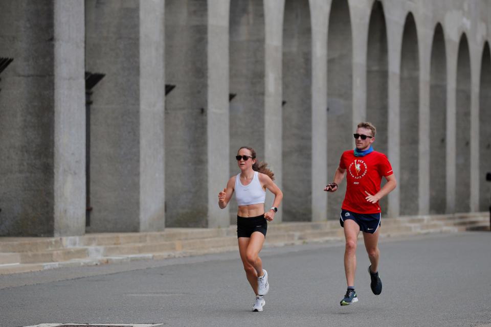 Molly Seidel (left) runs alongside her coach, Jon Green.