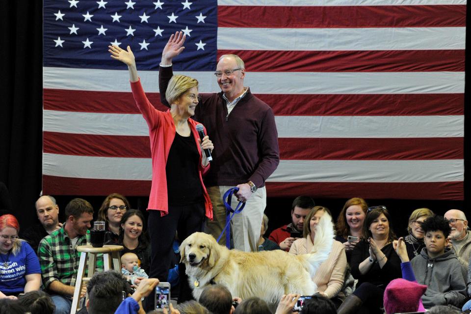 In this file photo taken on January 12, 2019 Senator Elizabeth Warren (D-MA), husband Bruce Mann and their dog Bailey take the stage before Warren addresses an Organizing Event as part of her exploratory presidential committee at Manchester Community College in Manchester, NH on Saturday.