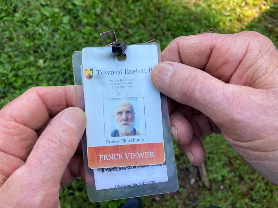 Exeter's fence viewer, Robert Fleischbein, displays the badge the town made for him.