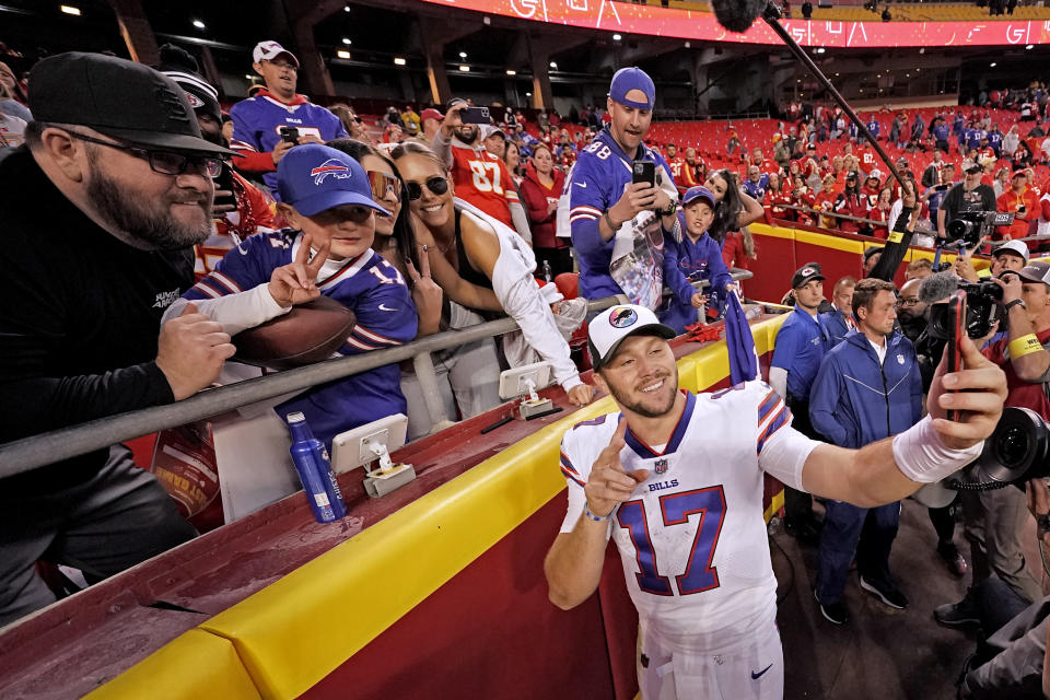 Buffalo Bills quarterback Josh Allen (17) takes a selfie with fans after an NFL football game against the Kansas City Chiefs Sunday, Oct. 16, 2022, in Kansas City, Mo. The Bills won 24-20. (AP Photo/Charlie Riedel)