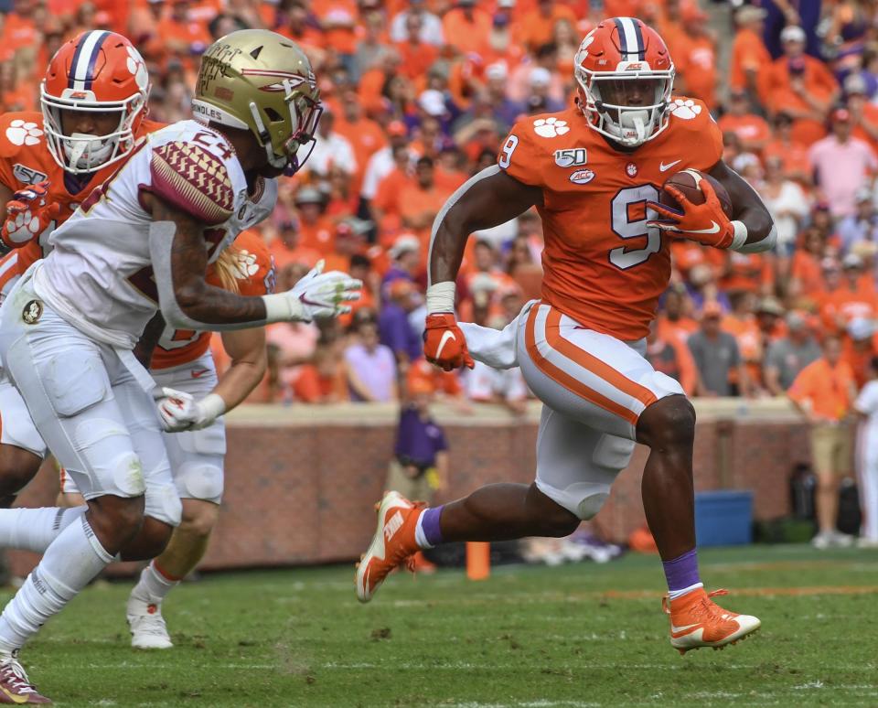 Clemson running back Travis Etienne (9) runs by Florida State defensive back Cyrus Fagan(24) during the first quarter at Memorial Stadium before the game with Florida State in Clemson, South Carolina Saturday, October 12, 2019.