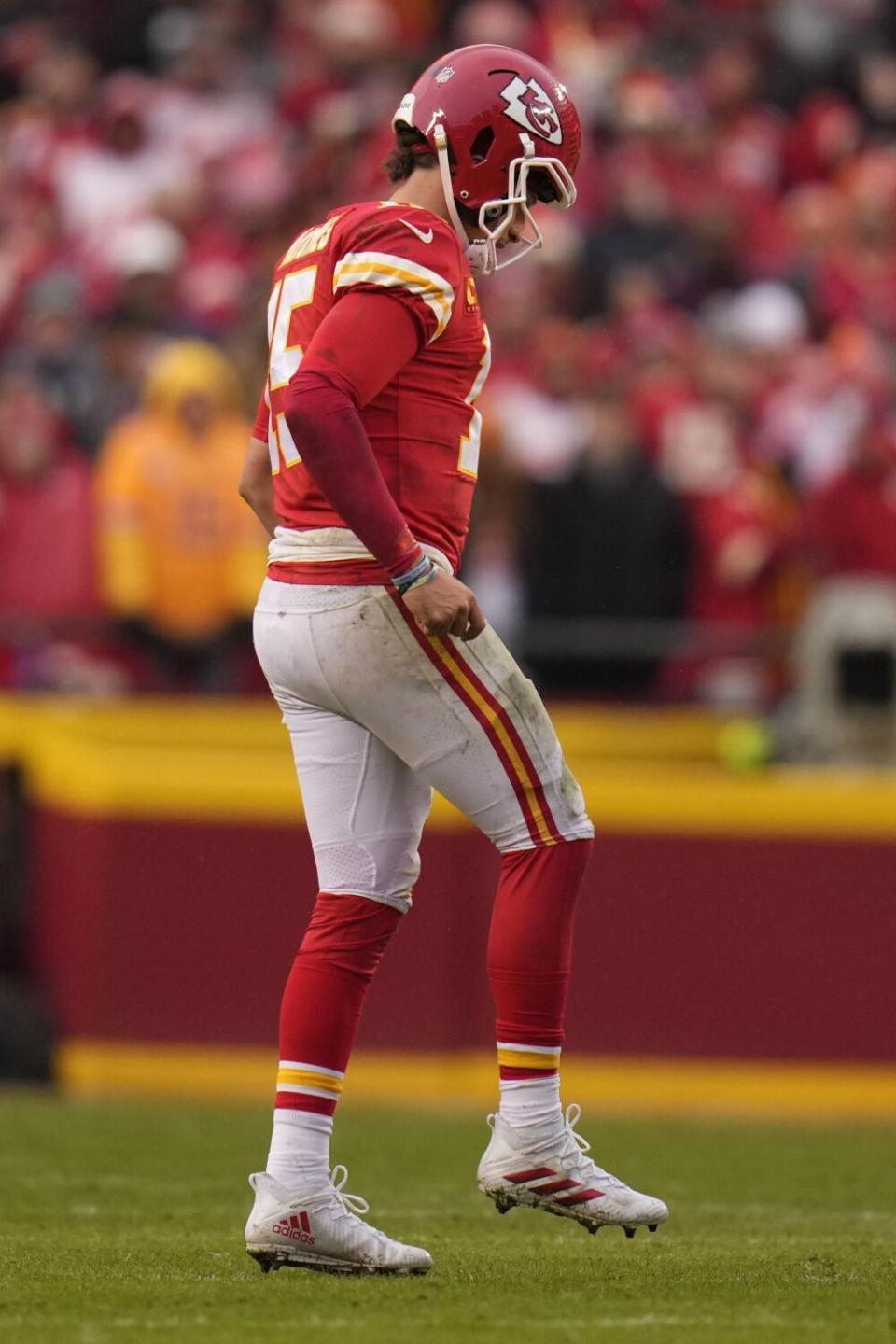 Chiefs quarterback Patrick Mahomes (15) limps back to the huddle after injuring his ankle against the Jaguars.