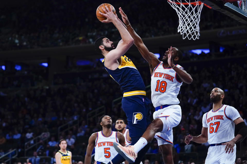 Indiana Pacers' Goga Bitadze, center, shoots over New York Knicks' Alec Burks (18) during the first half of an NBA basketball game Monday, Nov. 15, 2021, in New York. (AP Photo/Frank Franklin II)