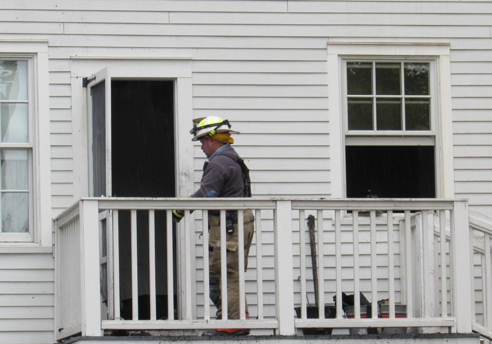 Stow Fire Capt. Jason Hartman walks into Heritage House, which was heavily damaged in a Sunday morning fire.