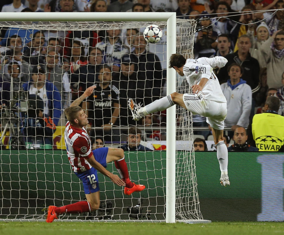 FILE - Real's Gareth Bale, right scores his side's 2nd goal, during the Champions League final soccer match between Atletico de Madrid and Real Madrid, at the Luz stadium, in Lisbon, Portugal, Saturday, May 24, 2014. (AP Photo/Daniel Ochoa de Olza, File)