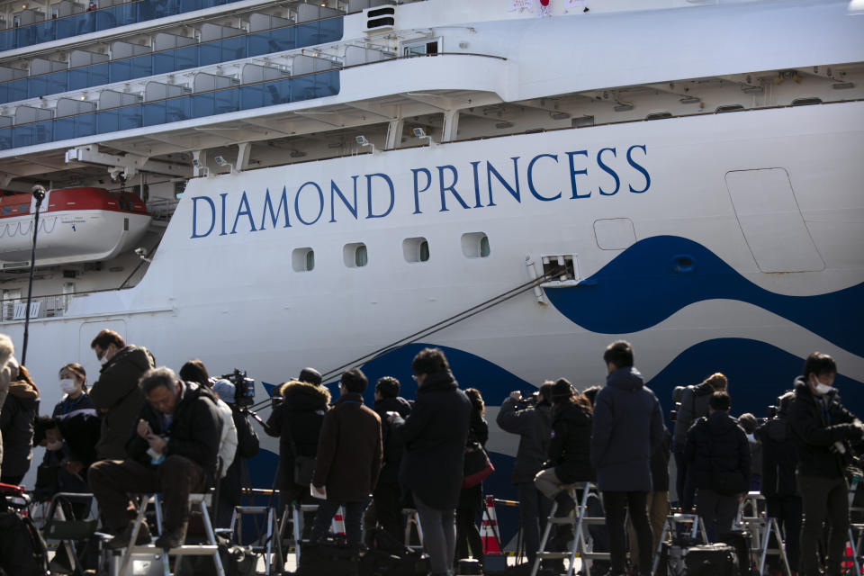 Media gather outside the quarantined Diamond Princess cruise ship in Yokohama, near Tokyo, Tuesday, Feb. 11, 2020. Japan's Health Minister Katsunobu Kato said the government was considering testing everyone remaining on board and crew on the Diamond Princess, which would require them to remain aboard until results were available. (AP Photo/Jae C. Hong)