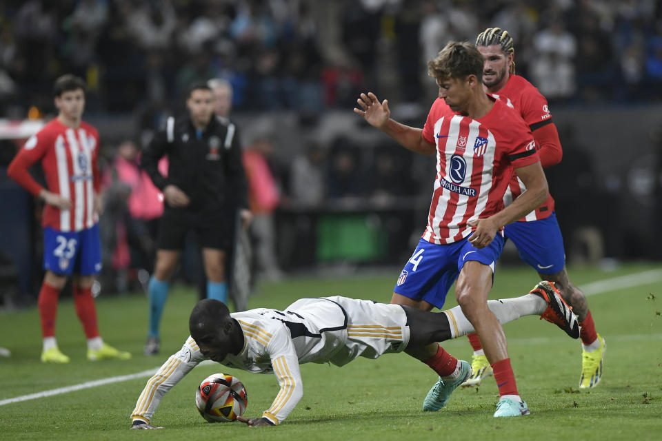 Real Madrid's Ferland Mendy falls on the ground during the Spanish Super Cup semi final soccer match between Real Madrid and Atletico Madrid at Al Awal Park Stadium in Riyadh, Saudi Arabia, Wednesday, Jan. 10, 2024. (AP Photo)