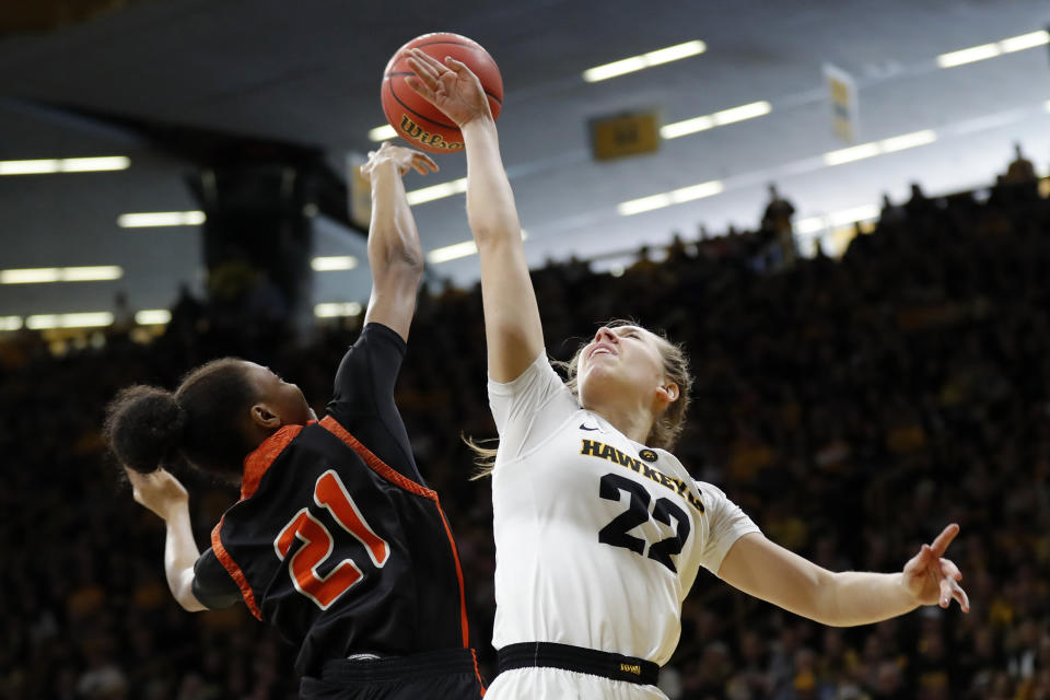 FILE - In this March 24, 2019, file photo, Mercer guard Shannon Titus blocks a shot by Iowa guard Kathleen Doyle, right, during a first-round game in the NCAA women's college basketball tournament in Iowa City, Iowa. Iowa has won six straight games and is on a 30-game home win streak, second-longest in the nation behind Baylor's 49-game streak. (AP Photo/Charlie Neibergall, File)