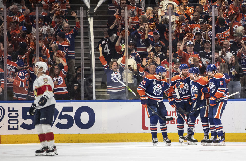 Edmonton Oilers' Leon Draisaitl (29), Brett Kulak (27), Dylan Holloway (55) and Cody Ceci (5) celebrate a goal against the Florida Panthers during the first period of Game 4 of the NHL hockey Stanley Cup Final, Saturday, June 15, 2024, in Edmonton, Alberta. (Jason Franson/The Canadian Press via AP)