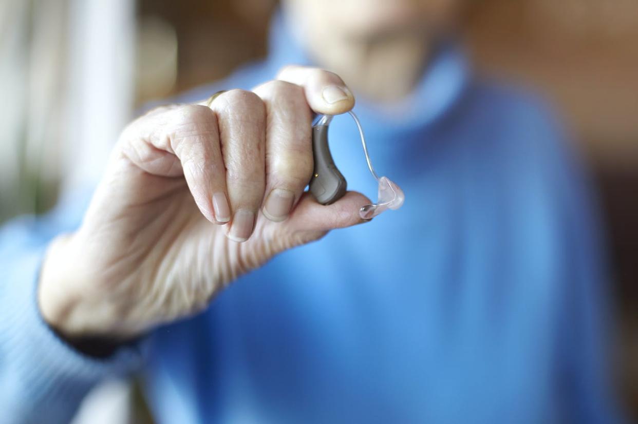 Over-the-counter hearing aids are now available at pharmacies and big-box stores. <a href="https://www.gettyimages.com/detail/photo/senior-woman-holding-hearing-aid-close-up-royalty-free-image/926841484?phrase=hearing%20aids&adppopup=true" rel="nofollow noopener" target="_blank" data-ylk="slk:Mara Ohlsson/Image Source via Getty Images;elm:context_link;itc:0;sec:content-canvas" class="link ">Mara Ohlsson/Image Source via Getty Images</a>
