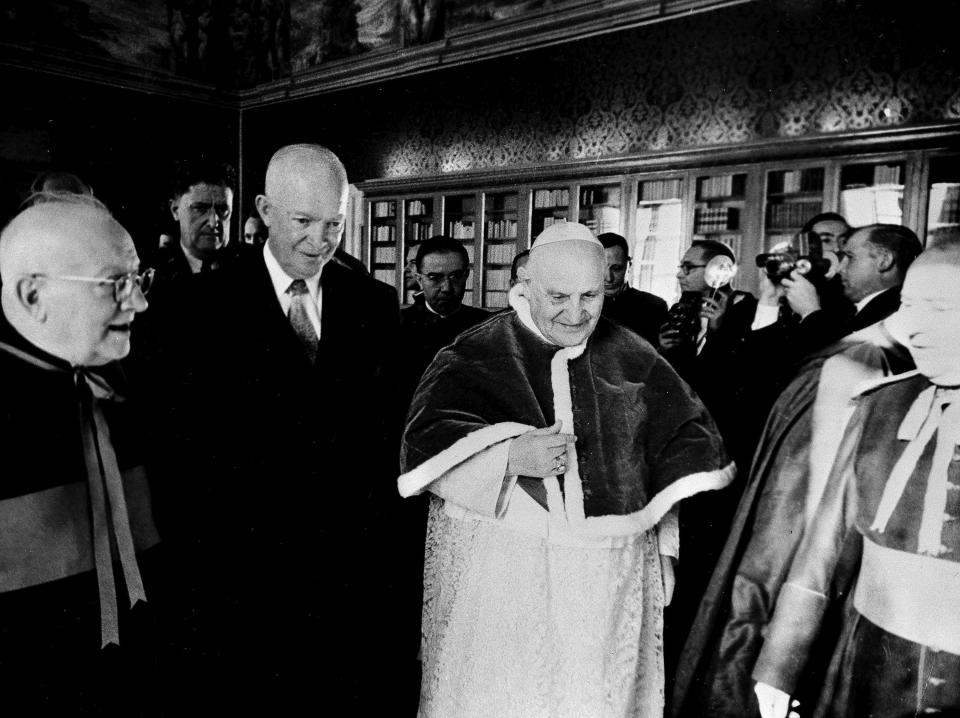 FILE- In this Dec. 6, 1959 file photo, President Dwight D. Eisenhower walks with Pope John XXIII at the Vatican. President Joe Biden is scheduled to meet with Pope Francis on Friday, Oct. 29, 2021. Biden is only the second Catholic president in U.S. history. (AP Photo/Paul Schutzer, File)