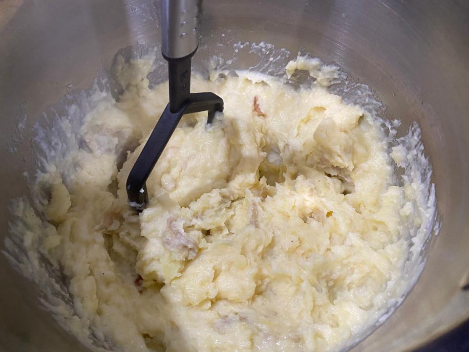 Guy Fieri process 2 mashing the potatoes