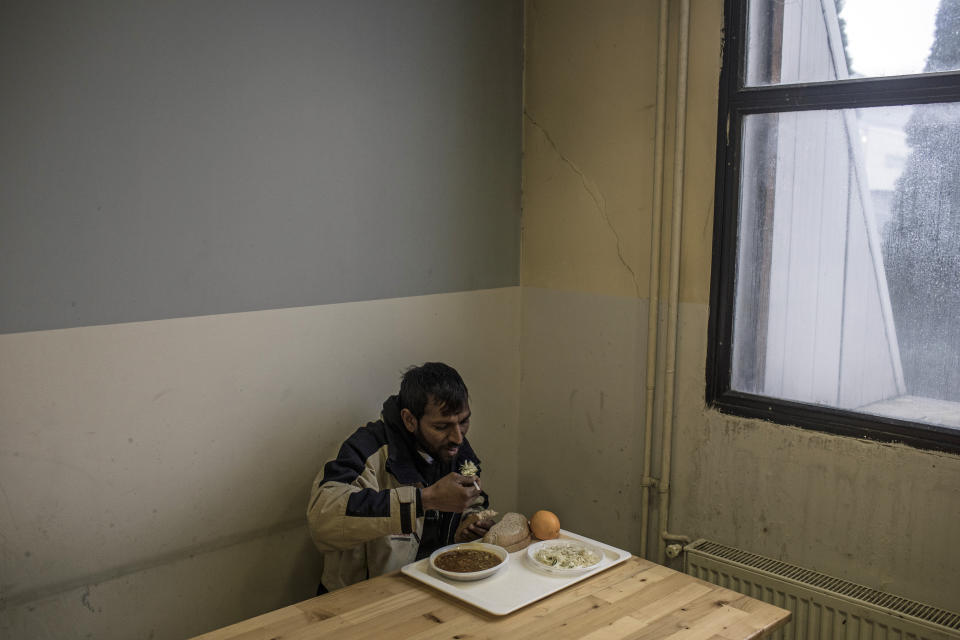 A migrant from Afghanistan eats at a temporary reception centre set up by the IOM (International Organization for Migrants) in Bihac, northwestern Bosnia on Dec. 12, 2019. (Photo: Manu Brabo/AP)