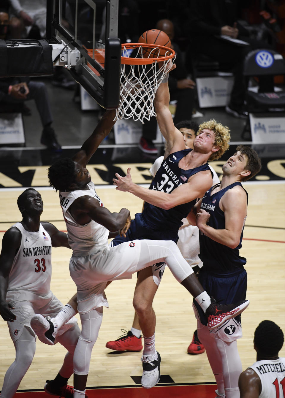 BYU forward Caleb Lohner (33) shoots over San Diego State forward Nathan Mensah (31) during the first half of an NCAA college basketball game Friday, Dec. 18, 2020, in San Diego. (AP Photo/Denis Poroy)