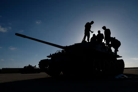 FILE PHOTO: Members of Libyan National Army (LNA) commanded by Khalifa Haftar, get ready before heading out of Benghazi to reinforce the troops advancing to Tripoli, in Benghazi, Libya April 13, 2019. REUTERS/Esam Omran Al-Fetori/File Photo