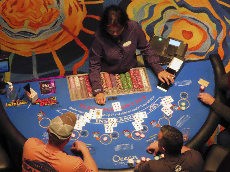 A dealer conducts a card game at the Ocean Casino Resort in Atlantic City, N.J., Dec. 2, 2022. Figures released April 10, 2023, by New Jersey gambling regulators show the city's nine casinos collectively posted a gross operating profit of $731 million in 2022, down 4.6% from the previous year. (AP Photo/Wayne Parry)