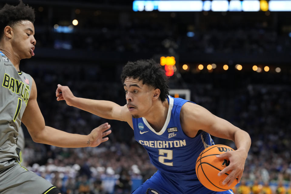 Creighton guard Ryan Nembhard, right, drives against Baylor guard Keyonte George during the second half of a second-round college basketball game in the men's NCAA Tournament on Sunday, March 19, 2023, in Denver. (AP Photo/David Zalubowski)