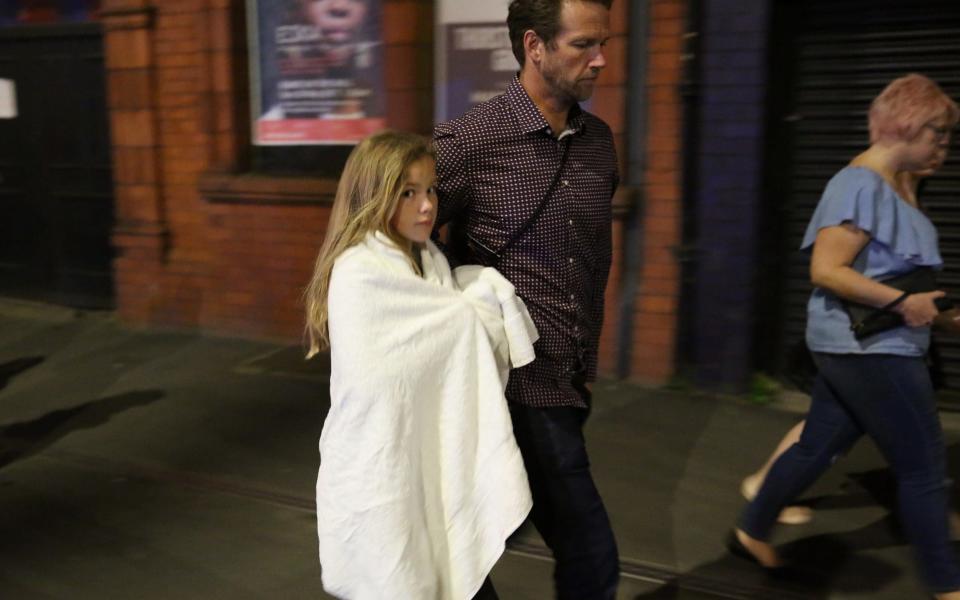 Police escort members of the public from the Manchester Arena - Credit: Getty