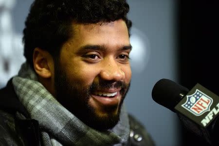 Jan 25, 2015; Phoenix, AZ, USA; Seattle Seahawks quarterback Russell Wilson fields and answers questions during at press conference at the Arizona Grand Hotel in preparation for Super Bowl XLIX. at Arizona Grand Hotel. Joe Camporeale-USA TODAY Sports