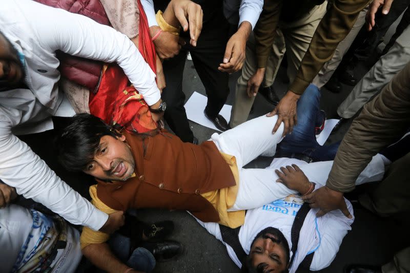 A supporter of India's main opposition Congress party reacts as he is detained along with party supporters outside the party headquarters, in New Delhi
