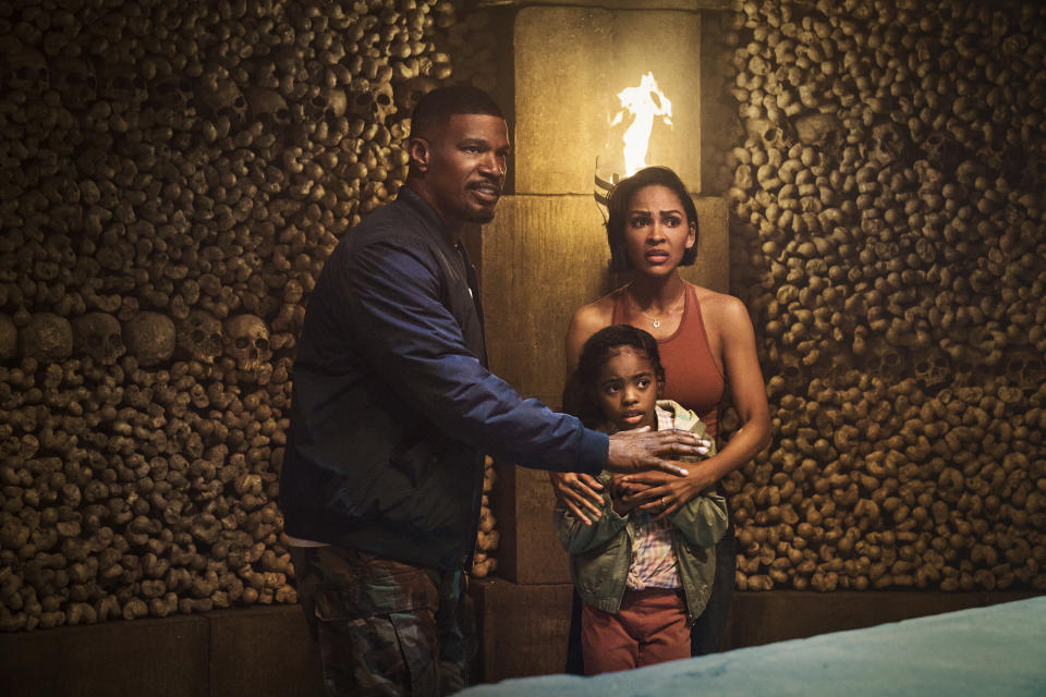 This image released by Netflix shows Jamie Foxx, from left, Zion Broadnax and Meagan Good in a scene from "Day Shift." (Parrish Lewis/Netflix via AP)