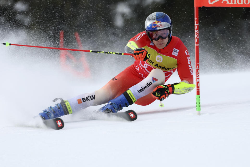 FILE - Switzerland's Marco Odermatt speeds down the course during a men's World Cup giant slalom race, in Soldeu, Andorra, Saturday, March 18, 2023. Amid growing environmental concerns surrounding the sport, the Alpine skiing World Cup season starts on a glacier in Austria this weekend with more races scheduled until March than ever before: 90, evenly divided between women and men. American star Mikaela Shiffrin and Swiss standout Marco Odermatt are regarded strong favorites to defend their overall titles from last year. (AP Photo/Alessandro Trovati)