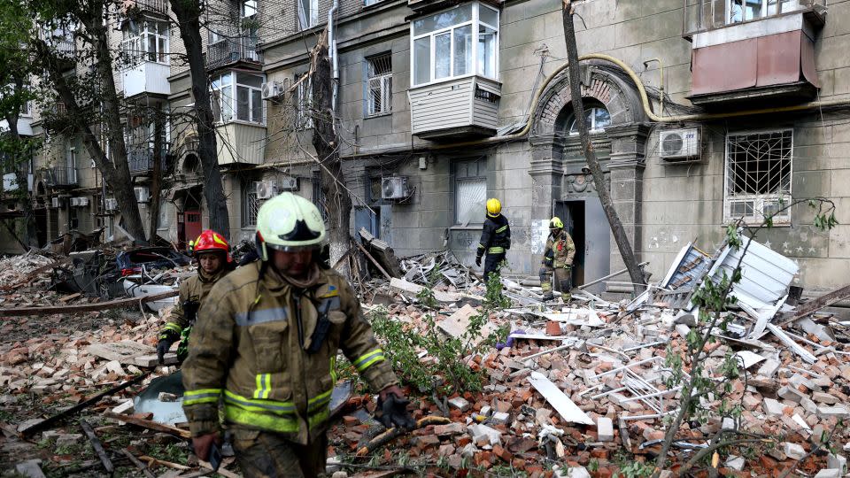 Ukrainian rescuers work in the courtyard of a damaged residential building in Dnipro, April 19, 2024. - Anatolii Stepanov/AFP/Getty Images