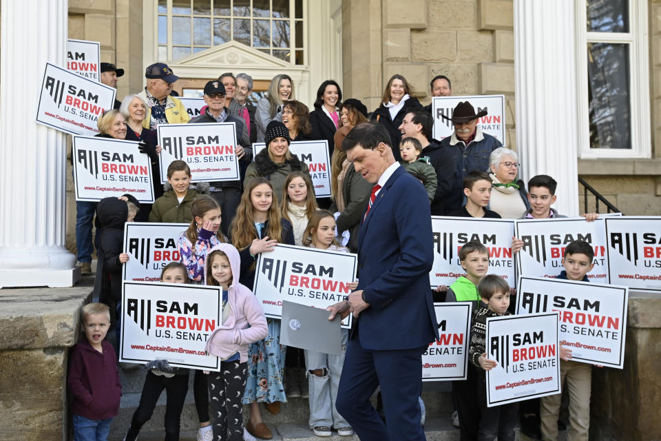 Republican U.S. Senatorial candidate Sam Brown stands next to supporters as he gets ready to speak after filing his paperwork to run for the Senate, Thursday, March 14, 2024, at the State Capitol in Carson City, Nev. Brown is seeking to replace incumbent U.S. Sen. Jacky Rosen. (AP Photo/Andy Barron)