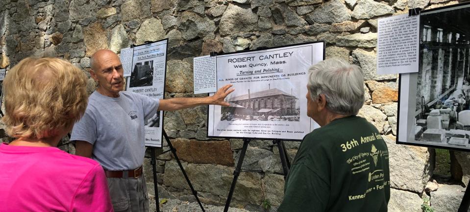 Al Bina, center, welcomes a group of hikers from the Milton Senior Center to the Quincy Quarry and Granite Workers Museum for a tour on Saturday, Sept. 3, 2022.