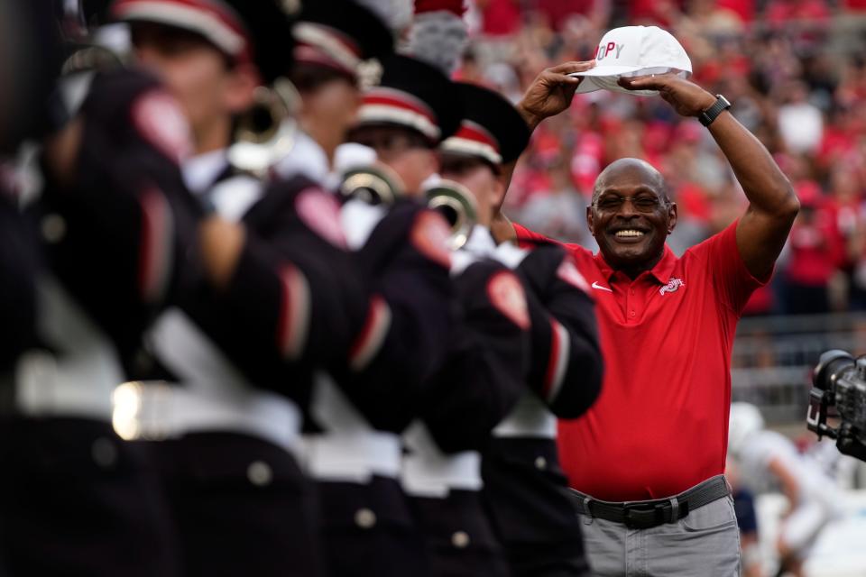 Aug 31, 2024; Columbus, OH, USA; Archie Griffin dots the i in Script Ohio with the Ohio State Marching Band during halftime of the NCAA football game between the Ohio State Buckeyes and the Akron Zips at Ohio Stadium.