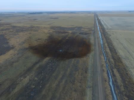 An aerial view shows the darkened ground of an oil spill which shut down the Keystone pipeline between Canada and the United States, located in an agricultural area near Amherst, South Dakota, U.S., in this photo provided November 18, 2017. REUTERS/Dronebase