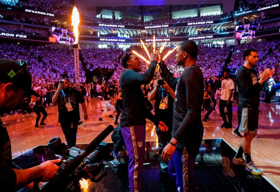 Sacramento Kings guard Malik Monk (0) and Sacramento Kings guard De’Aaron Fox (5) high-five during Game 1 of the first-round NBA playoff series at Golden 1 Center on Saturday, April 15, 2023.
