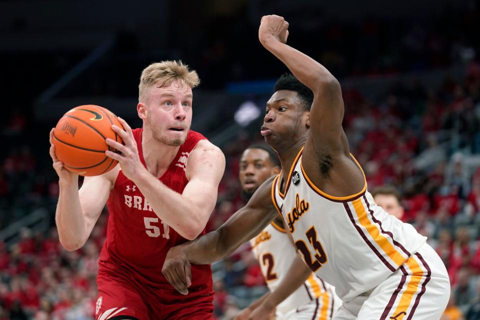 Bradley's Rienk Mast (51) heads to the basket as Loyola of Chicago's Chris Knight (23) defends during the first half of an NCAA college basketball game in the quarterfinal round of the Missouri Valley Conference tournament Friday, March 4, 2022, in St. Louis. (AP Photo/Jeff Roberson)