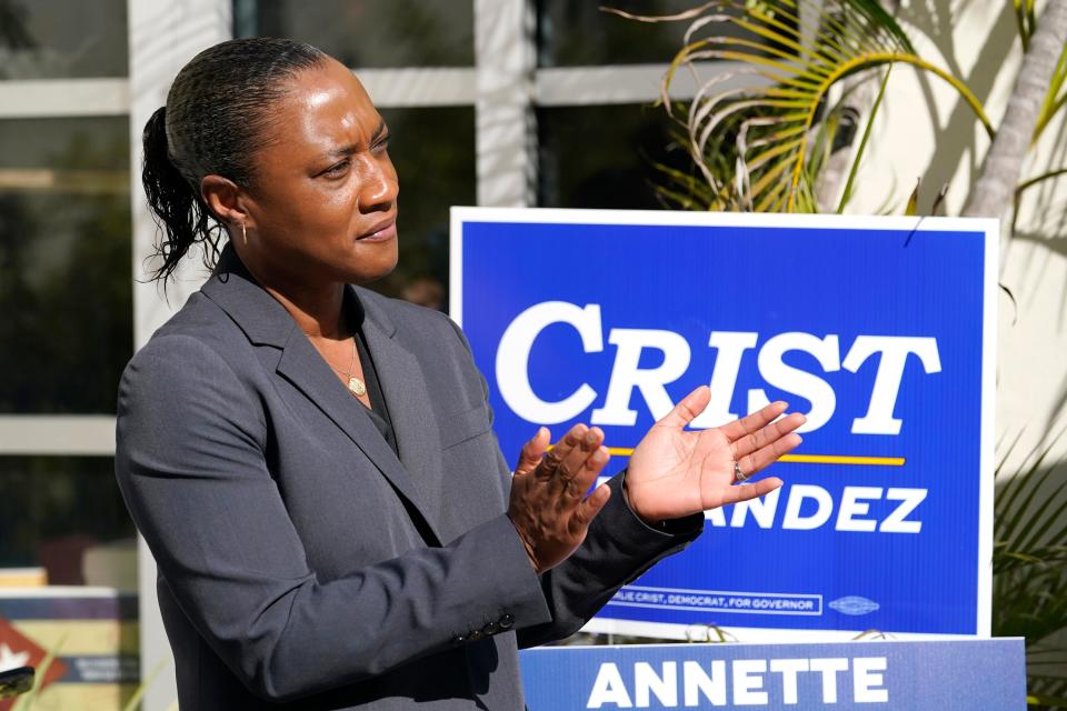 Laphonza Butler, president of EMILY's List, listens during a rally held by the Latino Victory Fund, Oct. 20, 2022, in Coral Gables, Florida.