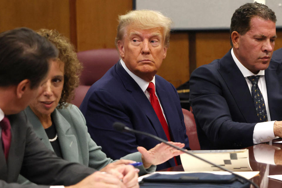 Former President Donald Trump appears in court with members of his legal team for an arraignment on charges stemming from his indictment by a Manhattan grand jury following a probe into hush money paid to adult film star Stormy Daniels in New York City, April 4, 2023. / Credit: ANDREW KELLY / REUTERS