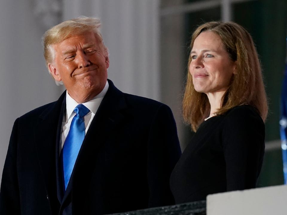 President Donald Trump and Amy Coney Barrett stand on the Blue Room Balcony after Supreme Court Justice Clarence Thomas administered the Constitutional Oath to her on the South Lawn of the White House White House in Washington, Oct. 26, 2020.