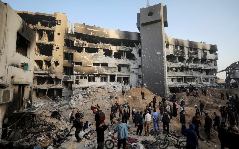 Palestinians inspect damages at Al Shifa Hospital after Israeli forces withdrew from the hospital