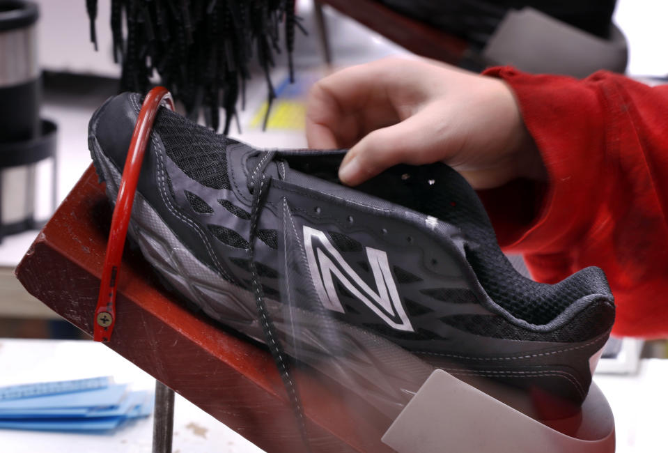 FILE- In this Dec. 17, 2018, file photo, a pair of athletic shoes designed for the military are laced up at a New Balance factory in Norridgewock, Maine. On Friday, Feb. 15, 2019, the Federal Reserve reports on U.S. industrial production for January. (AP Photo/Robert F. Bukaty, File)