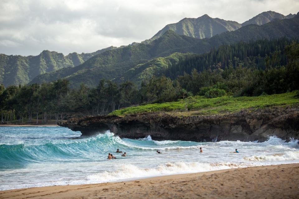 The Big Island of Hawaii is one of the most popular islands to visit. 
Picture: a Big Island beach with people enjoying the clear blue water 