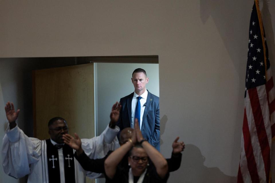 PHOTO: A U.S. Secret Service Agent stands guard as parishioners participate in a song, as U.S. President Joe Biden attends church service at Saint John Baptist Church in West Columbia, South Carolina, Jan. 28, 2024.  (Tom Brenner/Reuters)