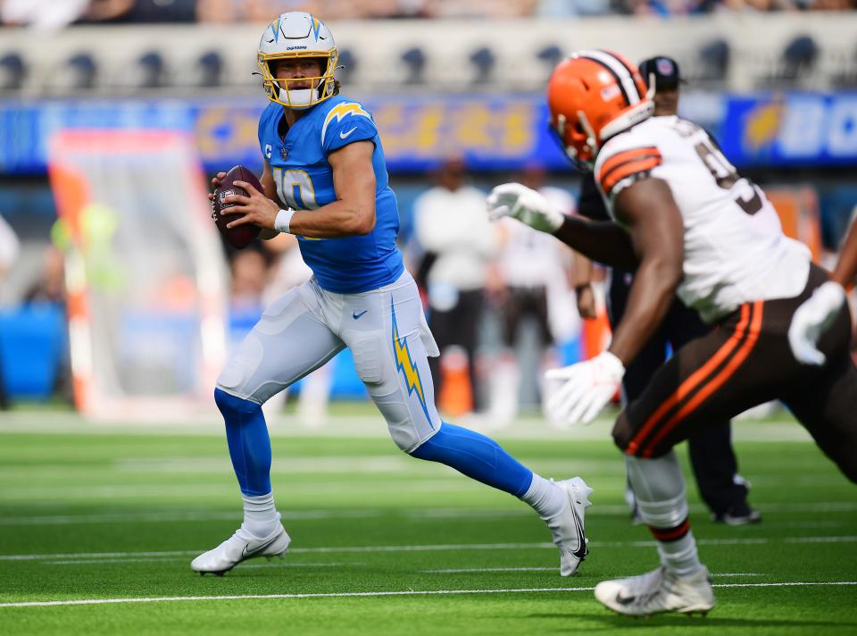 Los Angeles Chargers quarterback Justin Herbert (10) runs the ball against the Cleveland Browns during the first half at SoFi Stadium Oct. 10, 2021, in Inglewood, California.