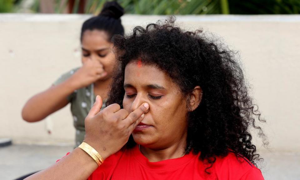 Indian yoga enthusiasts practices nadi suddi pranayama breatthing techniques.