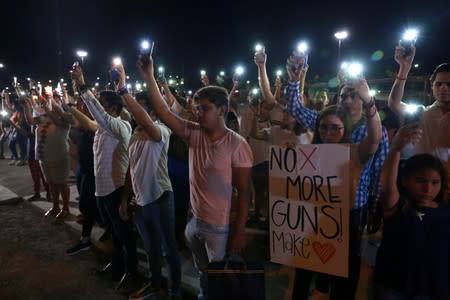 Mourners take part in a vigil near the border fence between Mexico and the U.S after a mass shooting at a Walmart store in El Paso U.S. in Ciudad Juarez