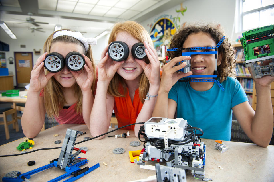 Three little girls playing with Meccano.