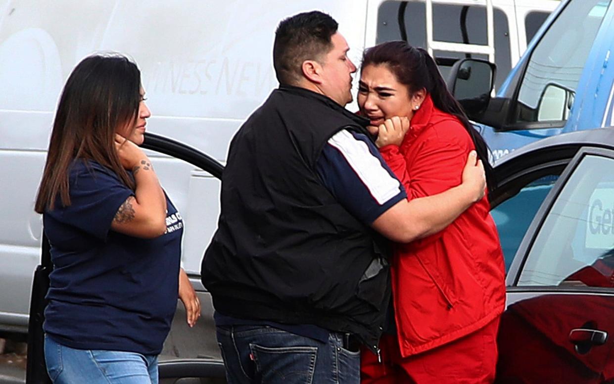 Fernando Juarez, 36, of Napa, center, embraces his 22-year-old sister Vanessa Flores, right, at the Veterans Home of California  - AP