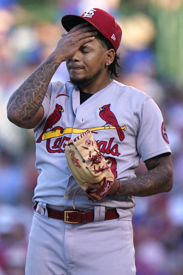 St. Louis Cardinals starting pitcher Adam Wainwright wipes his