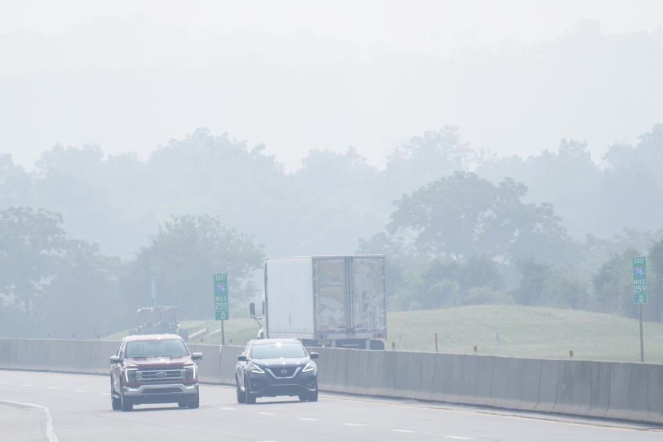 Vehicles drive in a haze from Canadian wildfires on Interstate 76 near Hershey, Pa., Thursday, June 29, 2023. (AP Photo/Matt Rourke)