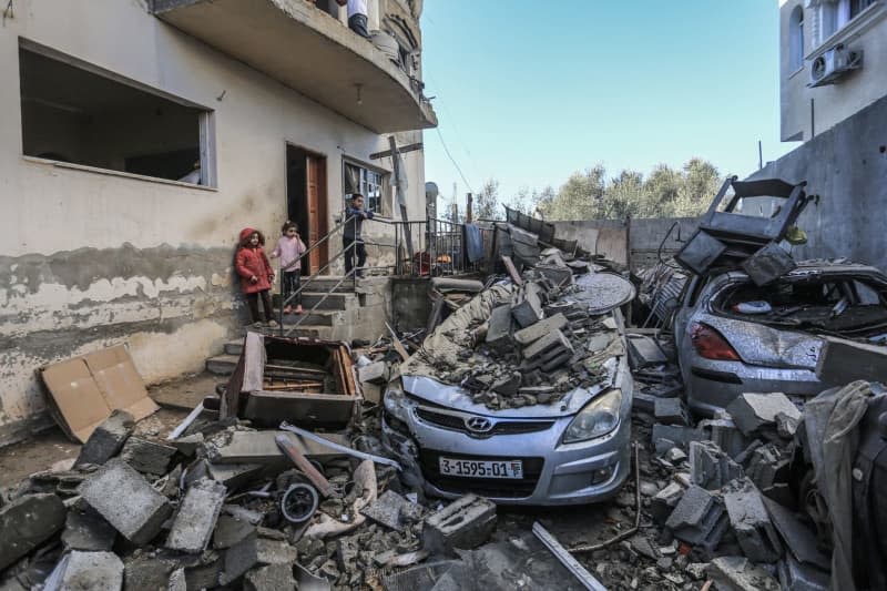 Palestinian children look on as they stand by rubble and debris of destroyed houses and vehicles in the aftermath of an Israeli bombardment, amid the ongoing battles between Israel and the Palestinian militant group Hamas. Mohammed Talatene/dpa