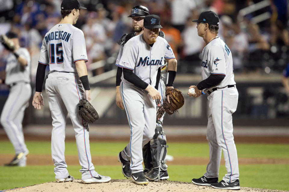 Miami Marlins manager Don Mattingly, right, takes relief pitcher Jeff Brigham, center, out of a baseball game after Brigham gave up three home runs during the seventh inning in the second game of a doubleheader against the New York Mets, Monday, Aug. 5, 2019, in New York. (AP Photo/Mary Altaffer)